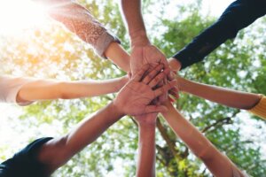 Hands of team coming together after huddle